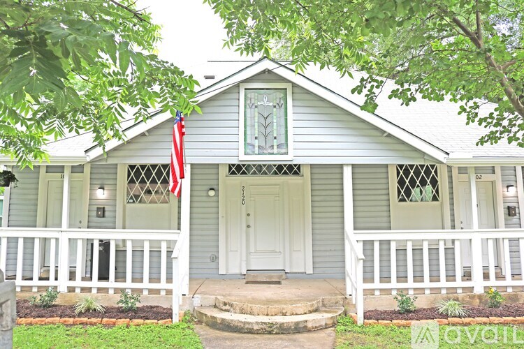 A house with a flag on the front porch.