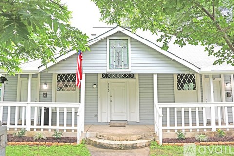 A house with a flag on the front porch.