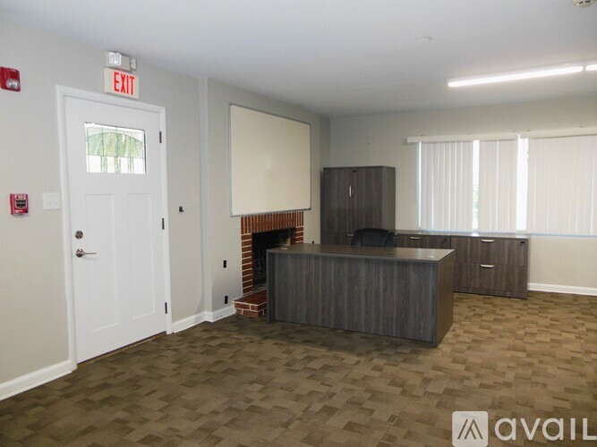 A room with a fireplace and a TV in it.