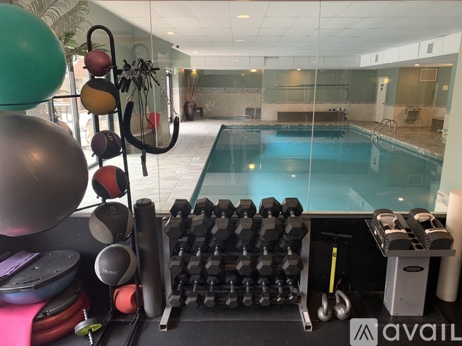 A gym with a pool table and exercise equipment.