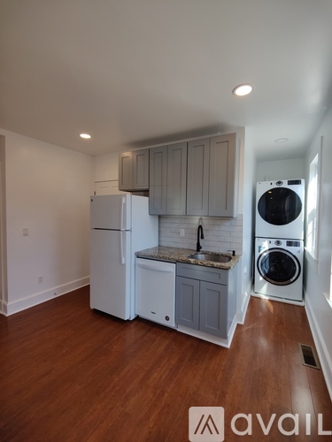 A kitchen with a washer and dryer built in.