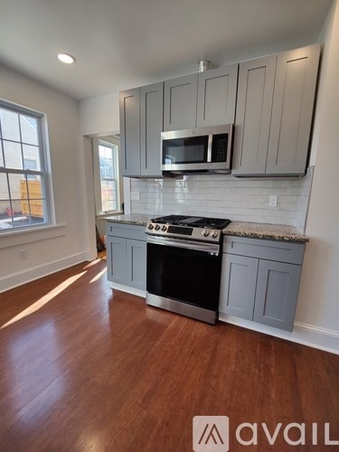 A kitchen with a stove top oven and microwave.
