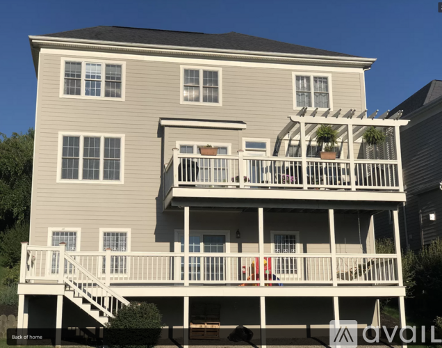 A two-story house with a balcony and a deck.