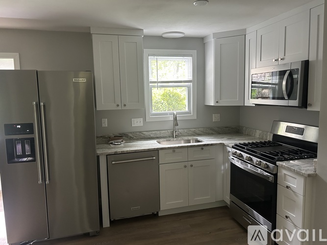 A kitchen with a stainless steel refrigerator and oven.