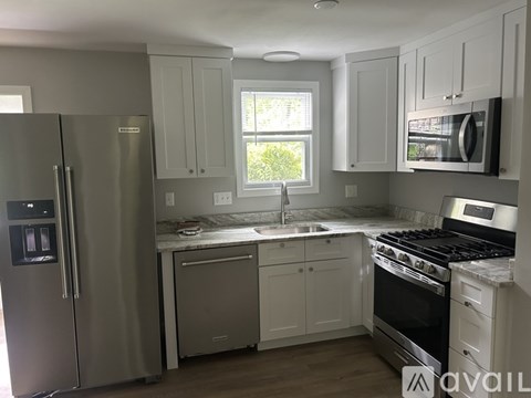 A kitchen with a stainless steel refrigerator and oven.