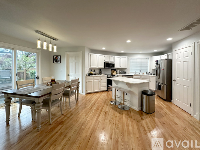 A kitchen with a table and chairs in the middle of the room.