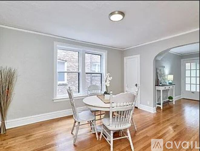 A dining room with a table and chairs.