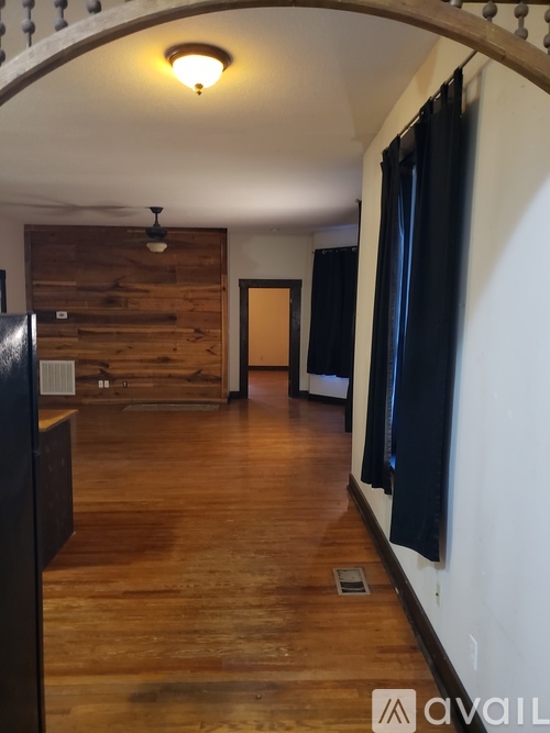 A room with wooden floors and a wooden door.