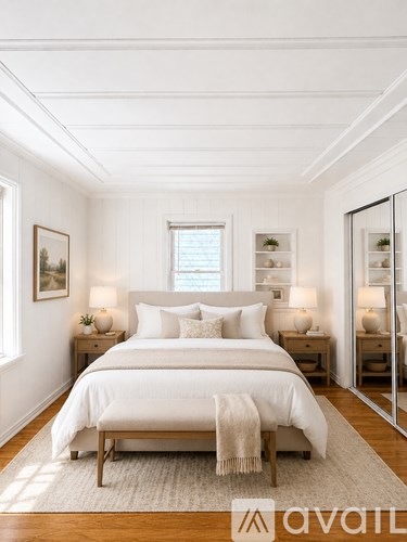 A bedroom with a large bed and a wooden floor.