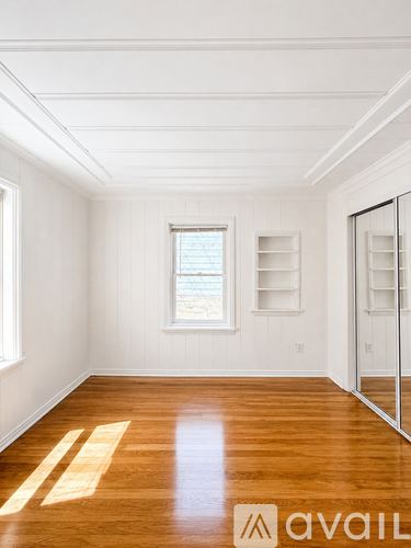A room with wooden floors and white walls.