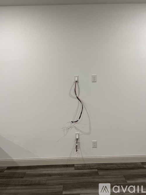 A wall socket with a cable plugged into it.