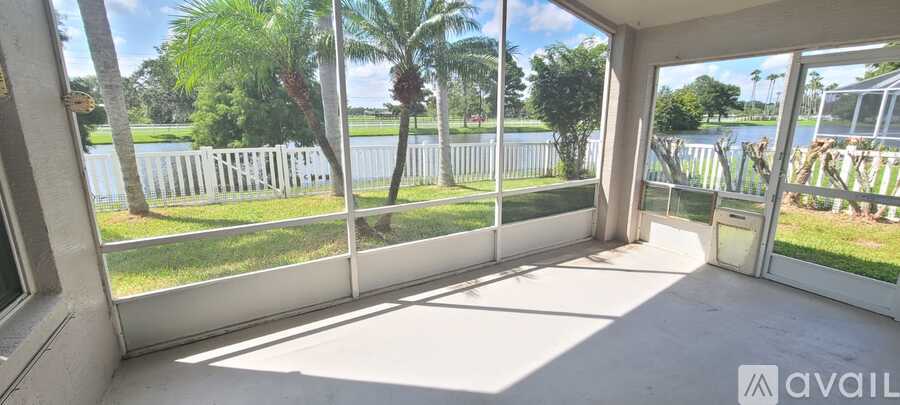 A balcony with a view of a lake and trees.