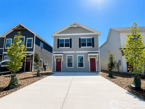A sunny day at a row of houses with the sun shining brightly in the sky.