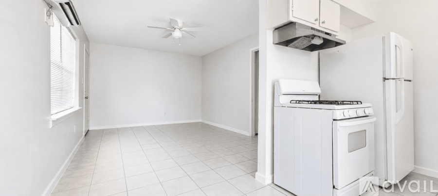 A small kitchen with a white fridge and stove.