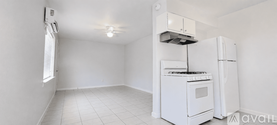A small kitchen with a white stove and refrigerator.