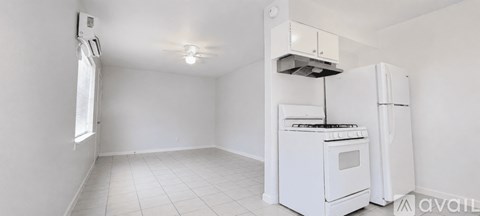 A small kitchen with a white stove and refrigerator.