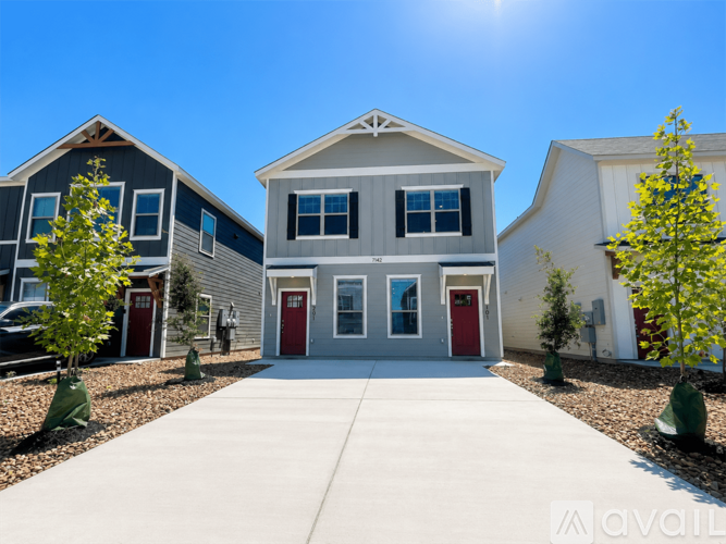 A sunny day at a row of houses with the sun shining brightly in the sky.