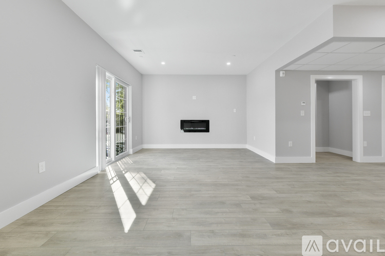 A spacious living room with a fireplace and a television.