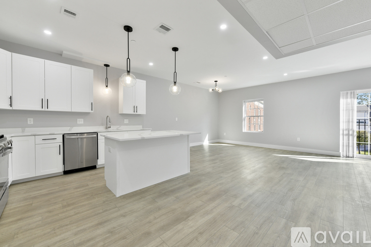 A modern kitchen with white cabinets and a large island.