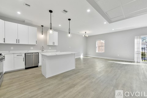 A modern kitchen with white cabinets and a large island.