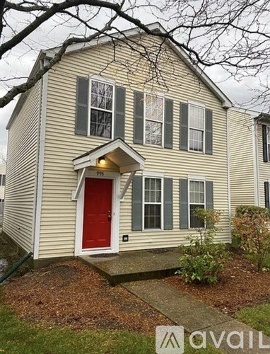 A house with a red door and a small front yard.