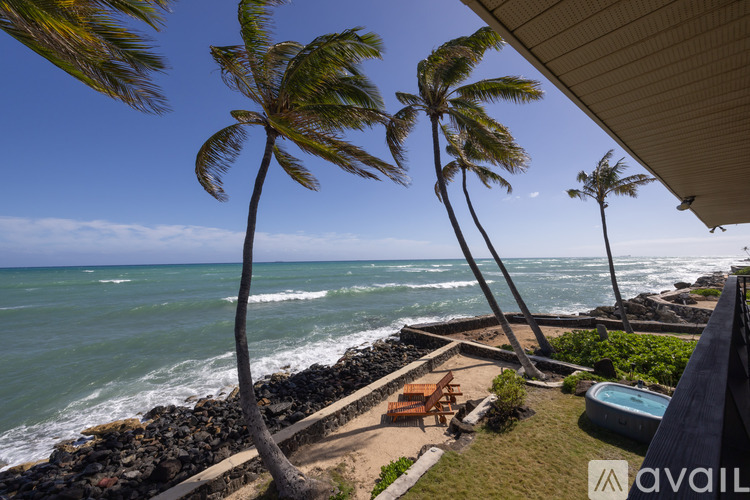 A beach scene with palm trees and a pool.