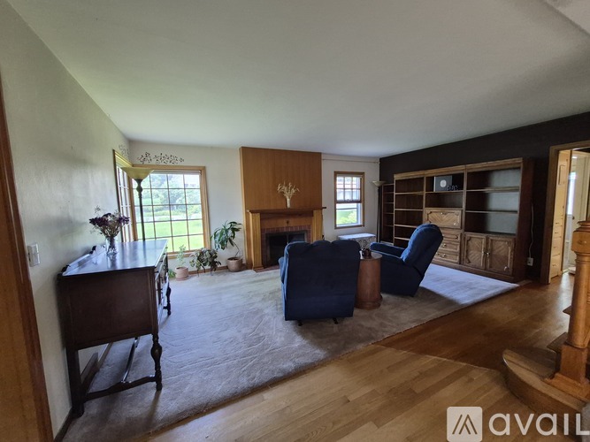 A living room with a blue sofa and a wooden floor.