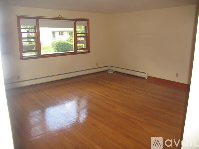 A room with wooden floors and a window.