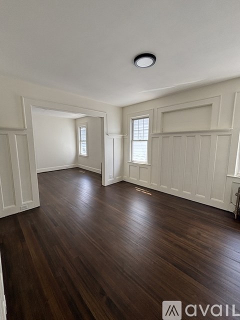 A room with wooden floors and white walls.