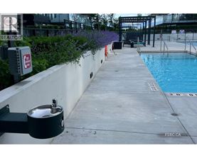 A pool area with a diving board and a pool ladder.