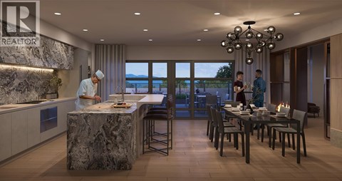 A modern kitchen with a marble island and a dining table set for two.