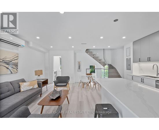 A modern living room with a grey sofa and wooden coffee table.