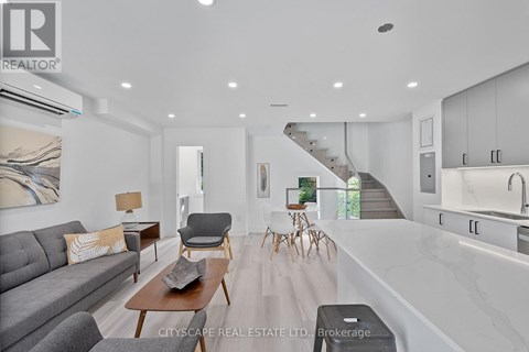 A modern living room with a grey sofa and wooden coffee table.