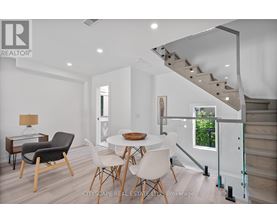 A dining room with a table and chairs.