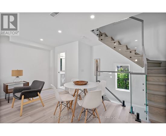A dining room with a table and chairs.