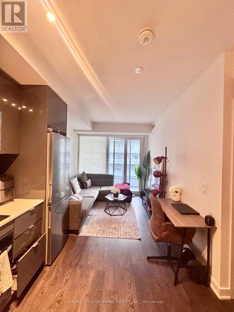 A well-lit kitchen with a dining table and chairs.