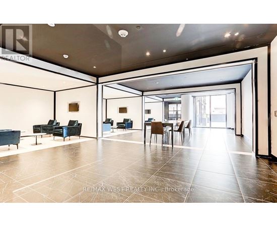 A spacious living room with a dining area and a kitchen in the background.