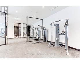 A spacious gym with a variety of equipment including treadmills, stationary bikes, and weight machines.
