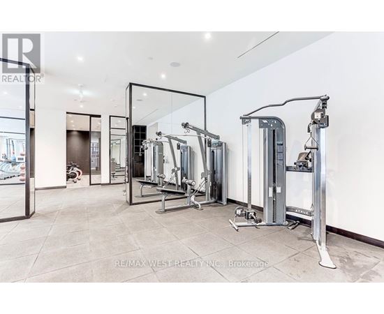 A spacious gym with a variety of equipment including treadmills, stationary bikes, and weight machines.