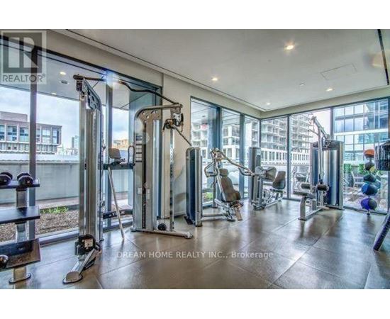A gym with a view of the city outside the windows.