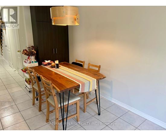 A dining room with a wooden table and chairs.