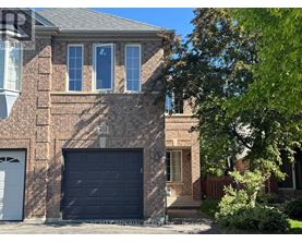 A house with a black garage door and a brick facade.