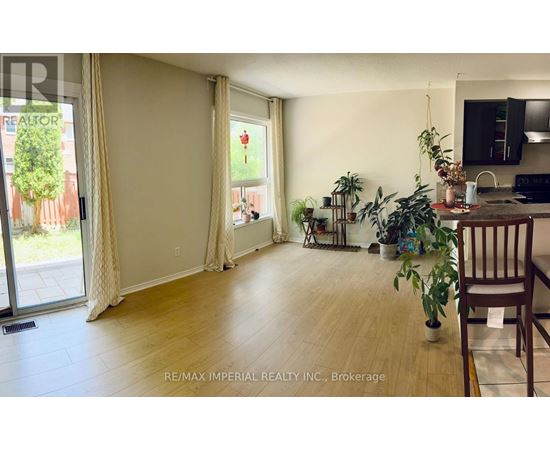 A living room with a sliding glass door and a dining area with a table and chairs.