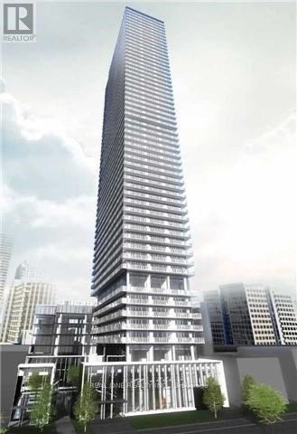 A tall, modern building with a glass facade and a curved section at the bottom.