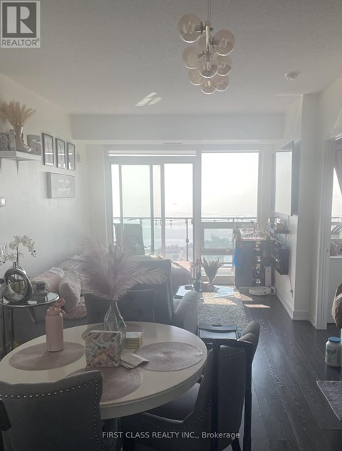 A dining room with a table set for two and a view of the ocean.