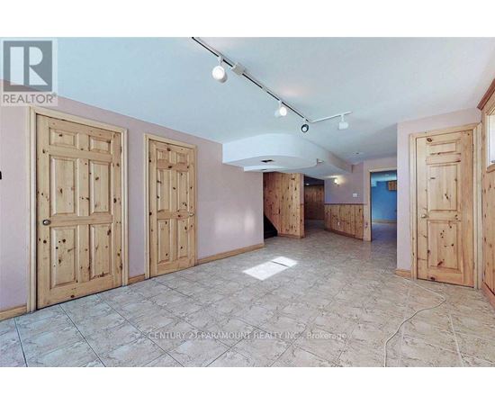 A room with wooden doors and a tiled floor.