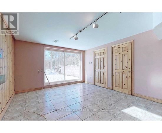 A room with a sliding glass door and tile flooring.