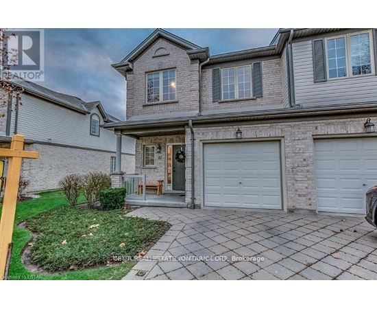A house with a grey facade and a white garage door.