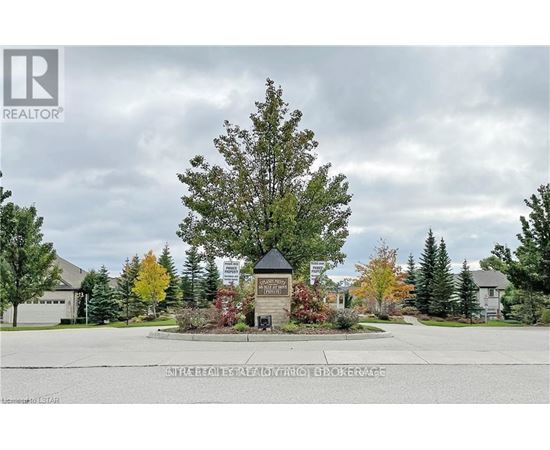 A realtor photo of a tree in front of a building.