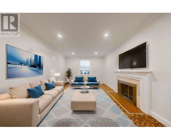 A living room with a beige couch, a blue cushion, a coffee table, a fireplace, and a painting on the wall.